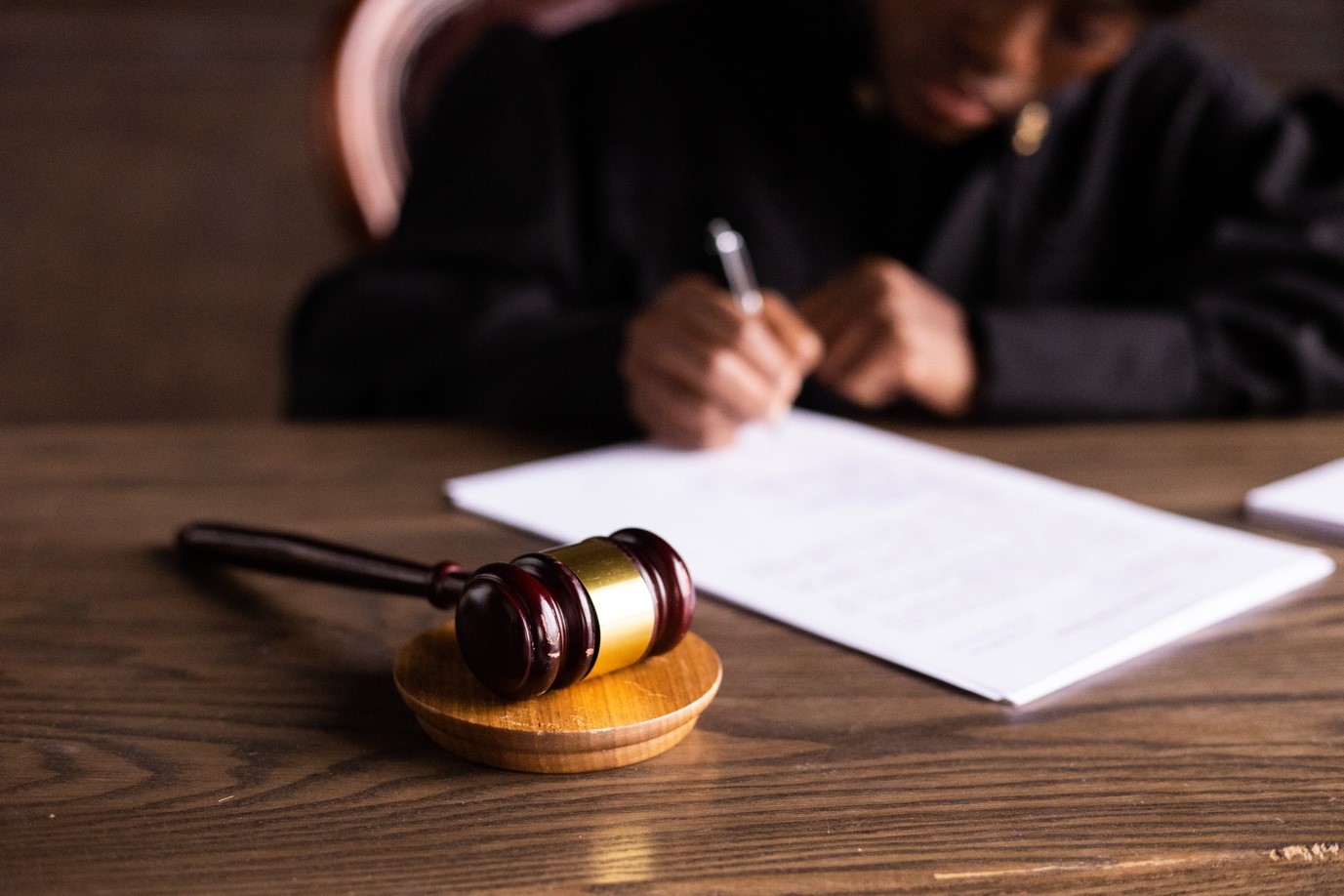 A judge signing legal documents in court